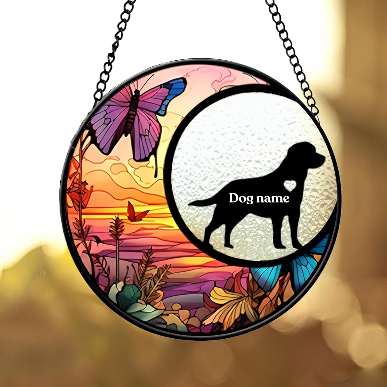 Round dog memorial glass suncatcher with a personalized pet name in a sunset composition
