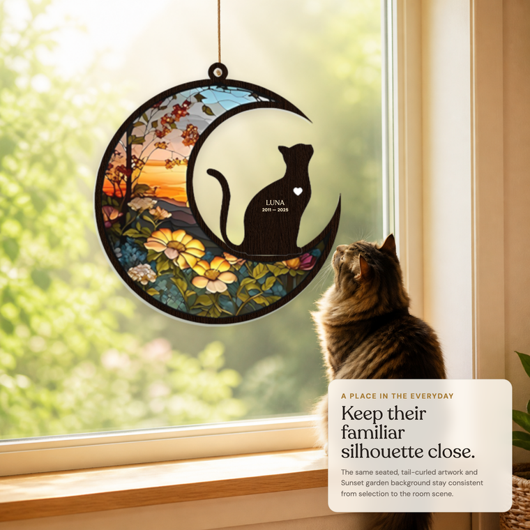 The unchanged M1 and cat-A memorial suncatcher with reference-calibrated inscription in a sunlit window scene