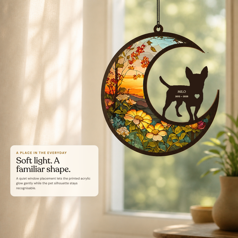 Personalized Chihuahua memorial suncatcher hanging in soft window light, with a translucent acrylic artwork layer and walnut wood front silhouette