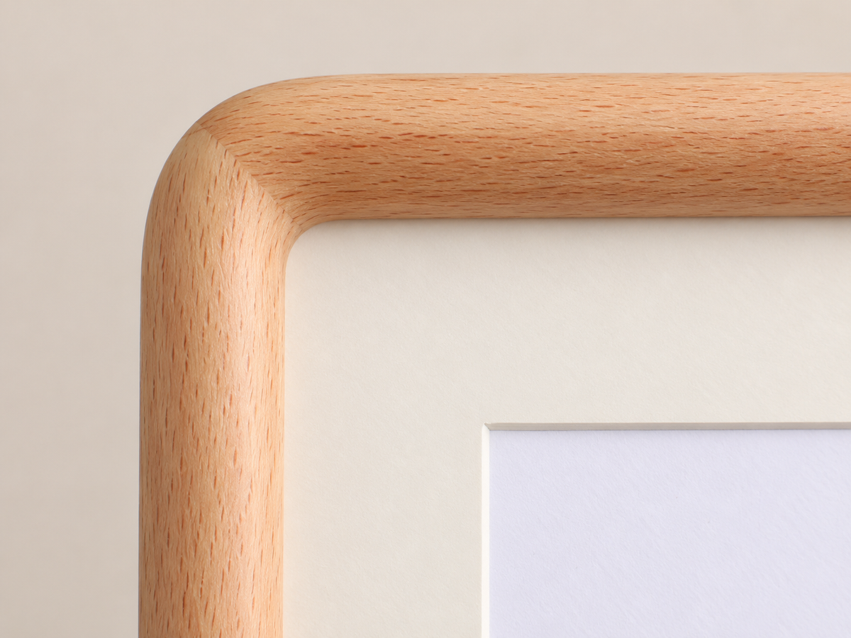 Illustrated close view of the rounded beech front corner and ivory mat.