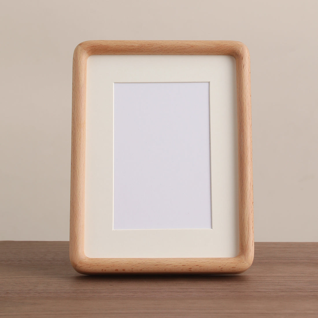 Empty rounded light-beech frame with an ivory mat, selected supplier front photograph.