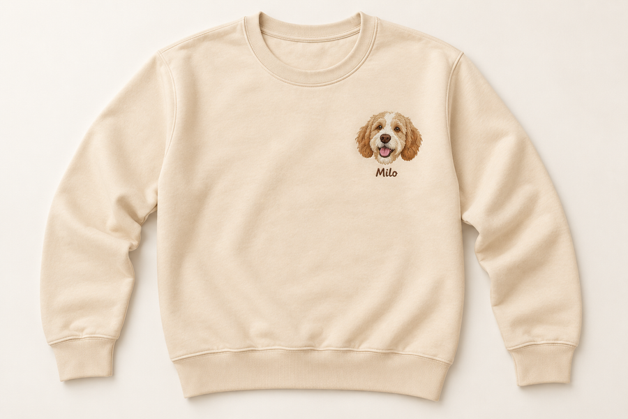 Apricot adult long-sleeve crewneck with a colored Milo pet head and optional name on the left chest.