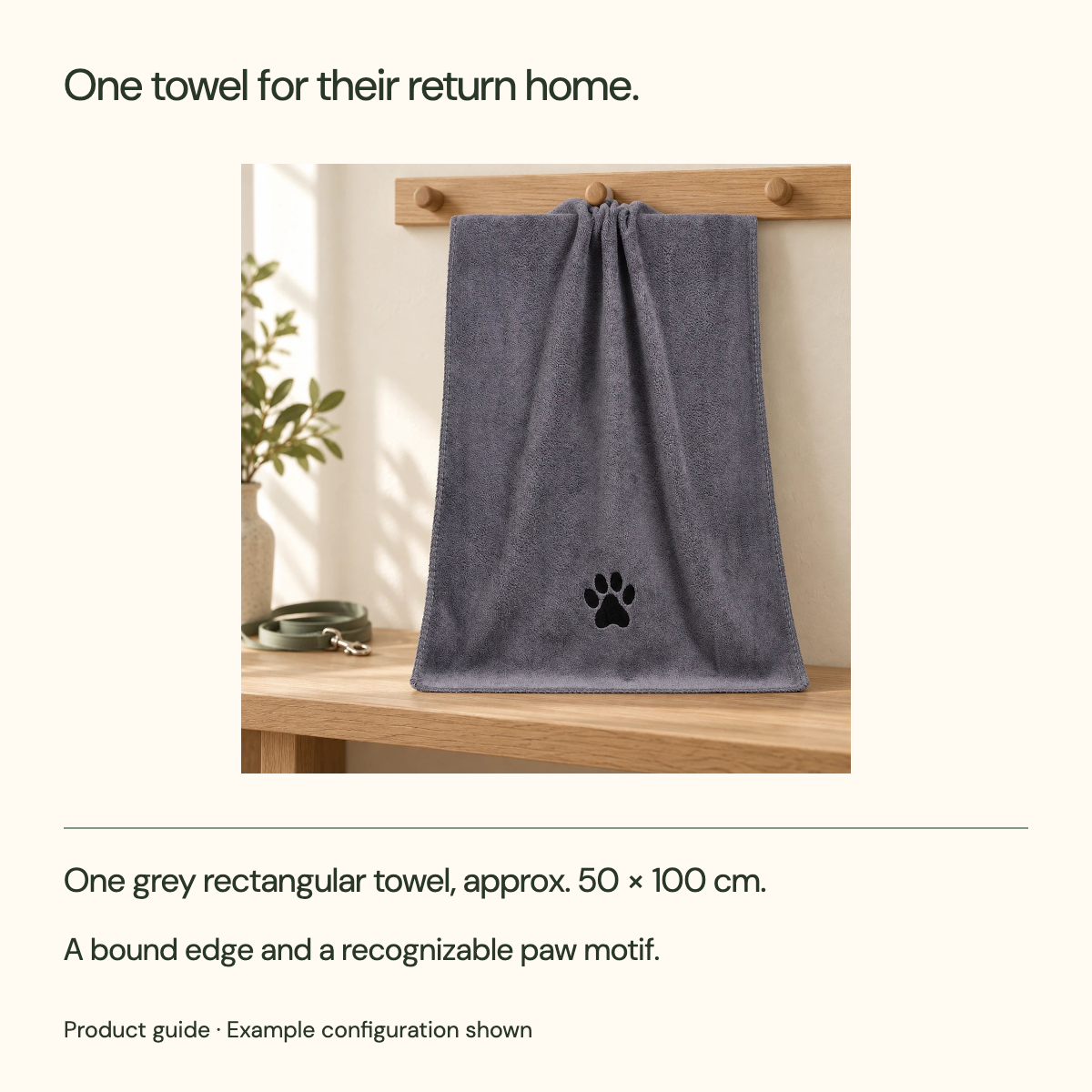 One towel for their return home. One grey rectangular towel, approx. 50 × 100 cm. A bound edge and a recognizable paw motif.