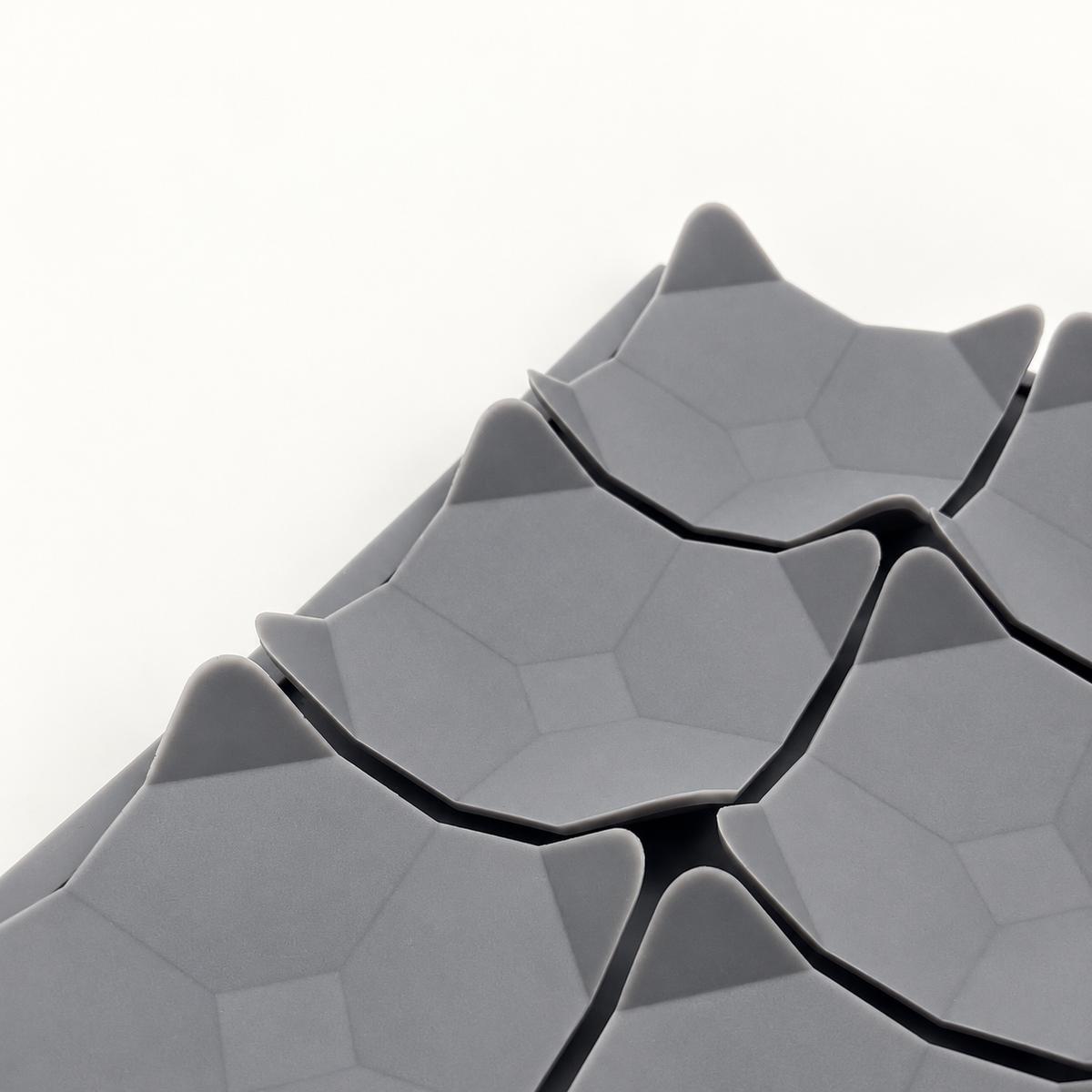 AI source-adapted close view of grey flexible leaf pockets and their vein pattern on one mat.