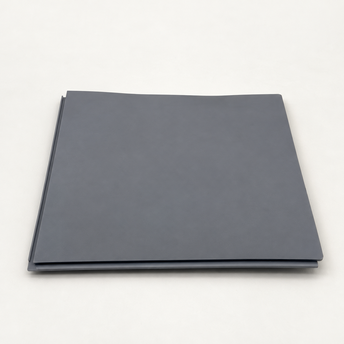 AI source-adapted view of the plain grey underside of one mat.