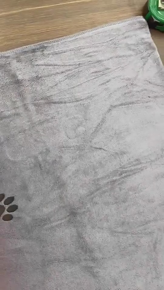 Close-up of the grey towel fabric and black paw motif