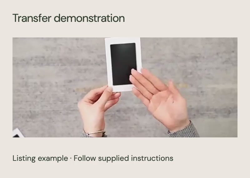Cropped and muted listing demonstration of the corresponding white-frame black clean-touch transfer pad used with a dog paw; not a BoxToHeart test or exact-size reference.